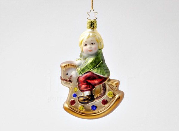 Christmas tree toy Innocent hearts. Boy on a rocking horse